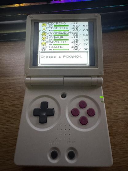 A GBA SP clone playing Pokemon Yellow via emulation. It is showing the Pokemon screen. The following pokemon  are listed:

Nidorinao level 22
Pidgeotto Level 22
Chaarmeleon L23
Ivysaur Level 26
Graveler Level 26
Pikachu Level 29