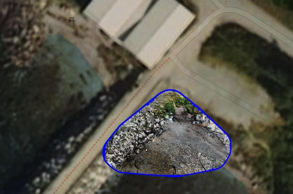 An overhead view of a small coastal scene - rocky beaches with a breakwater between them  and boathouses to the upper left. In the lower right is a high resolution image of a small rocky beach made by a drone mapping process, outlined in blue.