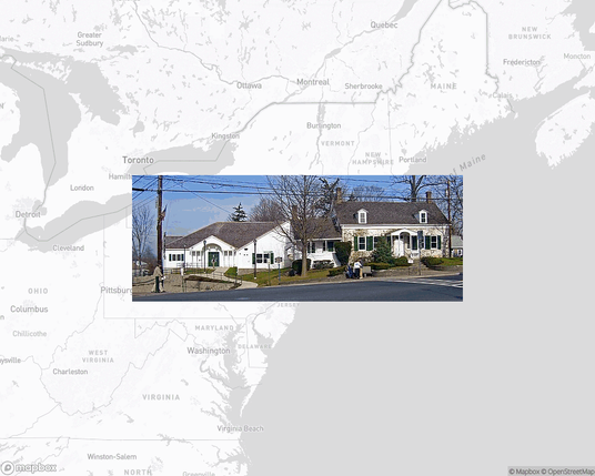 A photo of or from a library from the linked website, overlaid on a cropped world map where it's located.