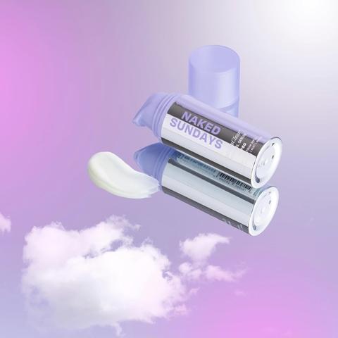 Three tubes of Naked Sundays product against a purple and pink background with clouds.