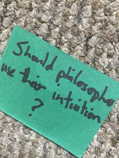Small green card with ‘should philosophers use their intuition? handwritten on it