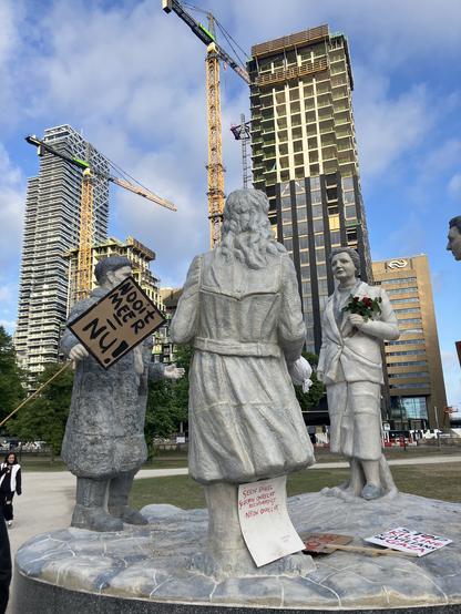 After the demonstration, signs were left at a statue for former Dutch queen Juliana.