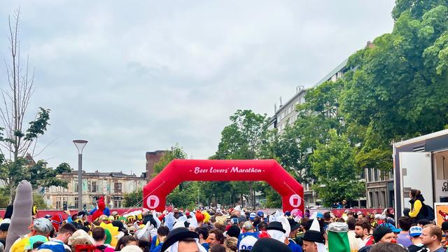 Getting ready to start the Beer Lovers’ Marathon! 
A crowd of runners gathering in front of an inflatable starting gate.