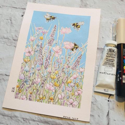 A small drawing of three bees with a mixed bed of flowers in pastel colours, the drawing has a blue background.  It is on off white pastel paper.
An original art work
Colour pencil and mixed media on acid free toned artist paper
5 by 7 inches (12.7 by 17.8 cm).
Sold unframed
