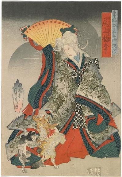 A bakeneko in the form of a woman with cats dancing at her feet.