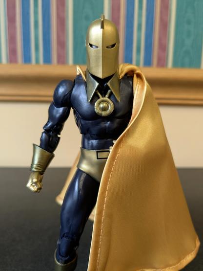 DC Multiverse Silver Age Doctor Fate (Platinum) standing with his cap draped over his left shoulder