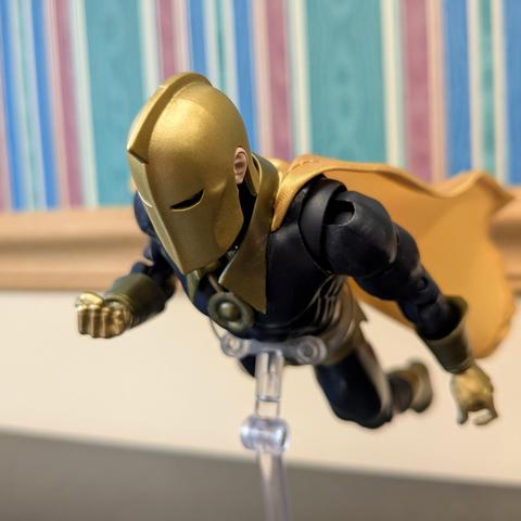 DC Multiverse Silver Age Doctor Fate (Platinum) on a stand flying toward the viewer's left