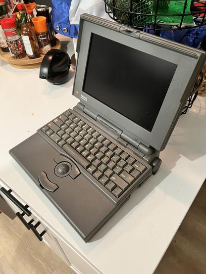Dark grey PowerBook 160 open.