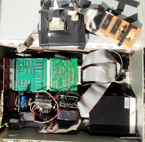 First sight on opening the metal box. The black microdrive cartridge box was used as a case for a 28 pin ZIF socket and my battery backed RAM / clock / EPROM emulator is plugged into it. You can see the power supplies at the bottom, looking a bit rusty, and the back of two expansion cards.