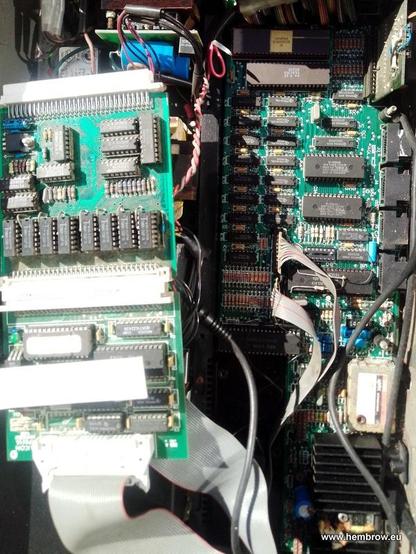 Removing the expansion cards reveals that one of them is a disk interface (for two 720K floppies also in the box) and the other is a 256 Kb memory expansion on which extra 41256 chips have been piggybacked to provide 512 Kb in total, above the 128 Kb on the motherboard. The motherboard itself all looks fairly clean, except for a nasty brown stain on the heatsink at the bottom.