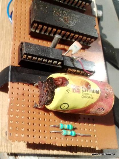 Close up of the eprom emulator. The lithium battery has leaked out some horrible brown stuff, which ended up on the heatsink inside the computer. Hopefully there isn't too much damage, but the DS1216 chip also looks to have corroded pins. The underside of this piece of veroboard has a lot of wires on it to connect everything up, and there are two switches at the back to switch from RW/RO mode and for two different EPROM pinouts. There's also a "dead cockroach" chip down there, which I don't remember the purpose of, but luckily no actual cockroaches were found...