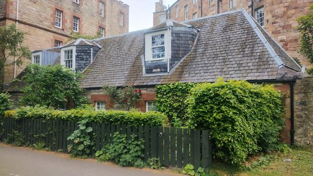 Terraced cottages surrounded by green hedges