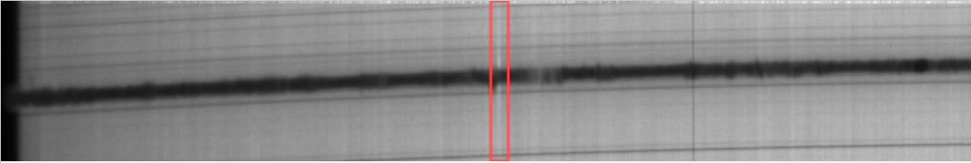 A view of the spectrum. A red rectangle delimits the region where an Ellerman bomb was detected. The bomb is visible as "moustaches" around the H-alpha line.