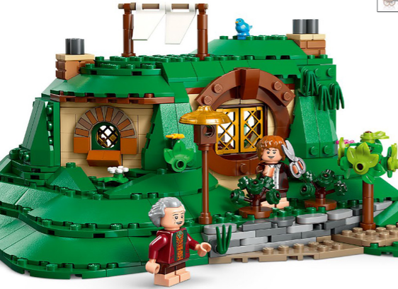 A Lego build of the side of a Hobbit-hole. Sam and Bilbo are standing outside. Sam is holding gardening shears.