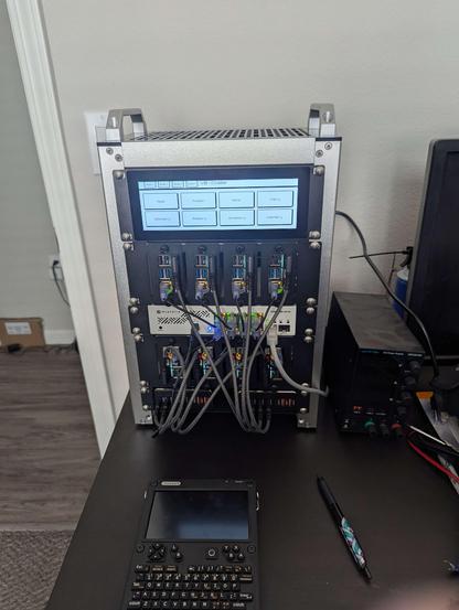 Photo of a mini rack with 8xpi5s, network switch, and 2u display