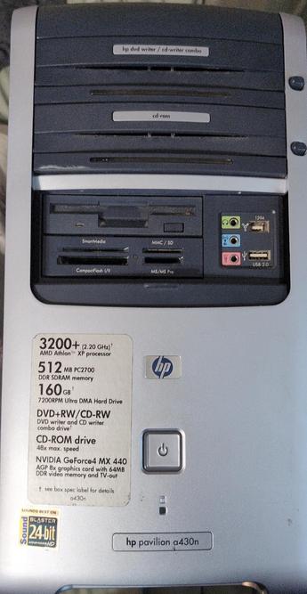 The image shows the back panel of an HP Pavilion a430n desktop computer. The top section features a DVD writer/CD writer combo drive and a CD-ROM drive, with labels indicating their functions. Below these drives, there is a card reader slot supporting various card types, including SmartMedia, MMC/SD, and CompactFlash I/II, as well as an M5/MS Pro slot. To the right, there are audio jacks for headphones and microphones, a 1394 port, and two USB 2.0 ports. A sticker on the lower left side lists the computer's specifications: a 3200+ (2.20 GHz) AMD Athlon XP processor, 512 MB PC2700 DDR SDRAM memory, a 160 GB 7200RPM Ultra DMA hard drive, a DVD+RW/CD-RW combo drive, a CD-ROM drive with a 48x maximum speed, and an NVIDIA GeForce4 MX 440 AGP 8x graphics card with 64MB DDR video memory and TV-out. The HP logo is prominently displayed in the center, and the model name "hp pavilion a430n" is printed at the bottom.