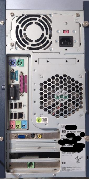 The image shows the back panel of an HP Pavilion a430n computer. The panel is primarily silver with a dark blue frame. On the left side, there are various ports including PS/2 connectors for keyboard and mouse, a serial port, a parallel port, USB ports, an Ethernet port, and audio jacks for line in, line out, and microphone. The center features a large hexagonal vent for the power supply fan, with a caution label warning that powered speakers are required for sound. Above the vent is a power input socket and a red power switch. The bottom right corner has a label with the model number, serial number, and other technical specifications, including compliance with Canadian and US standards. The image also shows screws securing the panel and a cooling fan at the top.