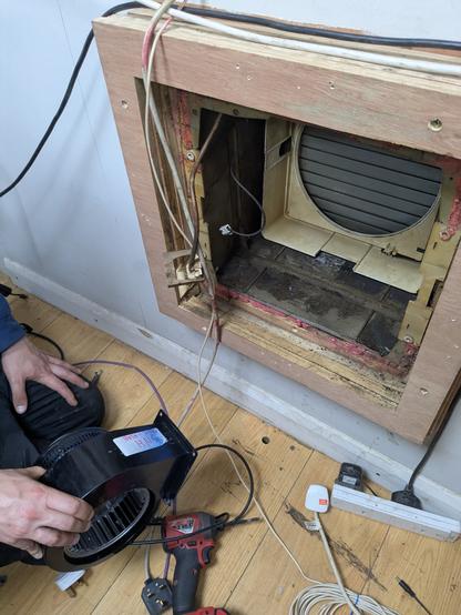 Test fitting the new fan in the extractor hole.