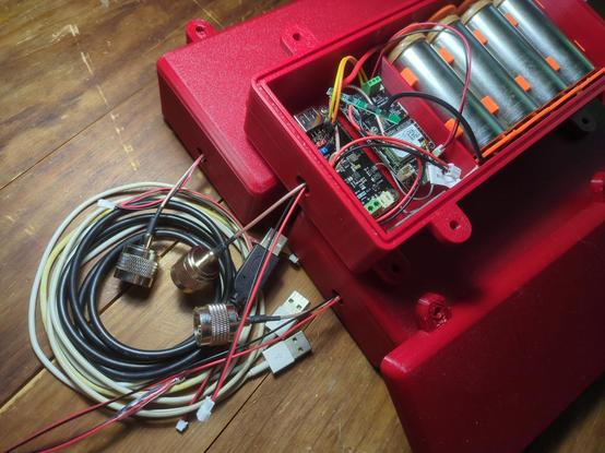 Three #solar powered #meshtastic nodes. The top one has the lid off to show the battery pack, radio, and MPPT board to get the most out of the solar panels. The solar panels are not pictured, but the USB power cables that will plug into them are in the foreground.