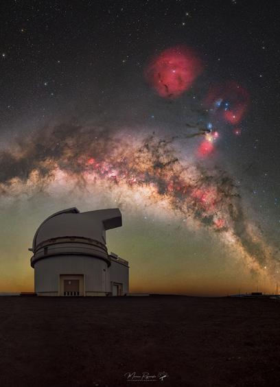 Portrait of the Milky Way in the background and an observatory in the foreground.