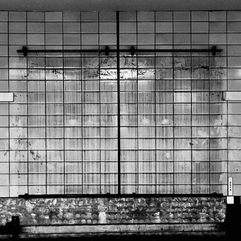 black and white photograph of a titled wall in the hamburg u-bahn. dark water stains streak the wall where an advertisement would  normally be hung.

advertising is killing photography.