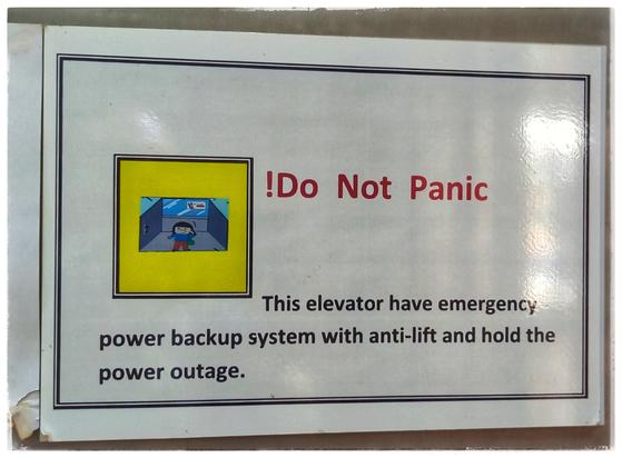 Sign, saying: 
!Do Not Panic
This elevator have  emergency power backup system with anti-lift and hold the power outage.