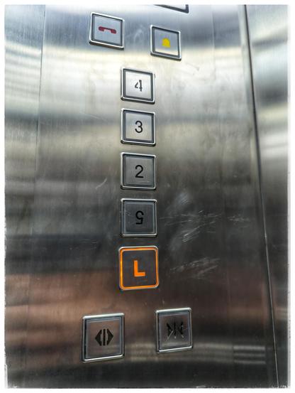 Buttons in a lift to navigate to the floors. Between button "L" and button "2" is a button with an upsidedown 5.