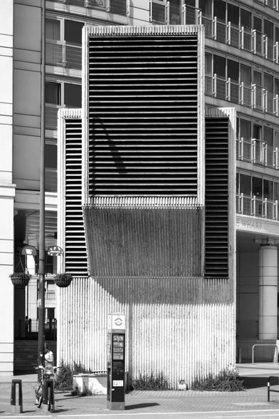 Monochrome photo of an large air vent for the Victoria line. In a Brutalist style with vertically-ribbed concrete texture. London Borough of Lambeth.
