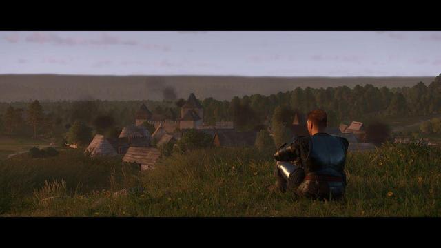 Henry sitting on a hill looking at the castle in the distance