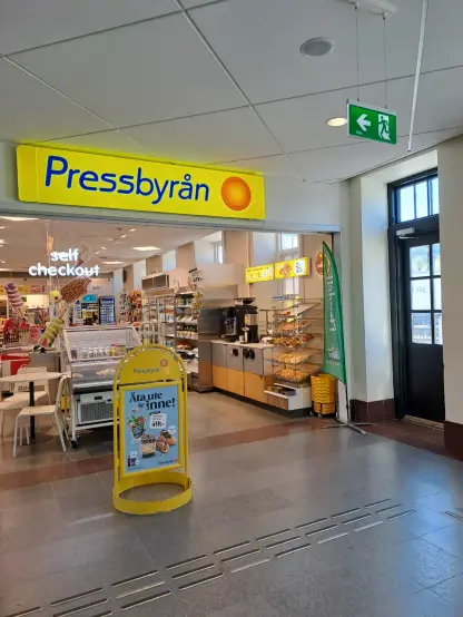 Photograph (colour): Entrance to a Swedish station shop called Pressbyrån