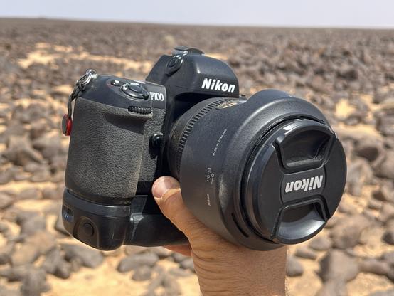 F100 held in my hand with the desert in the background.