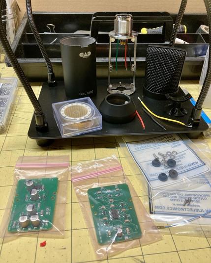 Photo of my build setup with all the components needed for the mic building last I am attempting. Wires. Mic capsule. Capsule saddle. Circuit boards. Mounting hardware. Mic body.