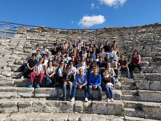A group picture of the school partecipants during an excursion at the Segesta theater archeological site. I can be spotted in a very bright orange t-shirt in the center.