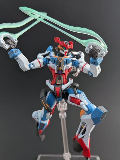 The HG GQuuuuuuX on a stand attacking something to the viewer's right with both beam sabers