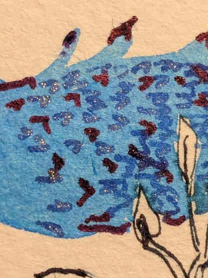 Close up of scales showing the violet sheen and the sparkly blue of the scales.