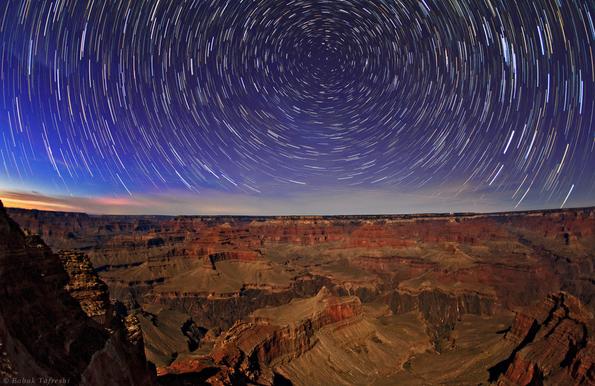 2013 March 3

Grand Canyon Star Trails
 * Image Credit & Copyright: Babak Tafreshi (TWAN)

Explanation: 
One of the natural wonders of planet Earth, the Grand Canyon in the American southwest stretches across this early evening skyscape. The digitally stacked sequence reveals the canyon's layers of sedimentary rock in bright moonlight. Exposed sedimentary rock layers range in age from about 200 million to 2 billion years old, a window to history on a geological timescale. A recent study has found evidence that the canyon itself may have been carved by erosion as much as 70 million years ago. With the camera fixed to a tripod while Earth rotates, each star above carves a graceful arc through the night sky. The concentric arcs are centered on the north celestial pole, the extension of Earth's rotation axis into space, presently near the bright star Polaris. 

Authors & editors: Robert Nemiroff (MTU) & Jerry Bonnell (UMCP)
NASA Official: Phillip Newman Specific rights apply.
NASA Web Privacy Policy and Important Notices
A service of: ASD at NASA / GSFC
& Michigan Tech. U.