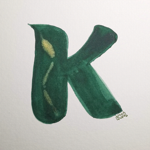 Watercolor of upper case letter K in a lovely shade of green with gold swirls.