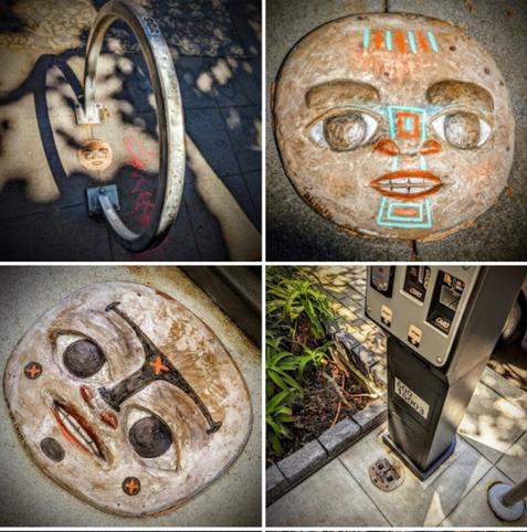 Painted face sculpture installed as street art tags. Top row is titled: 'copper held in mouth'. Bottom row: 'The sprite of the glacier'