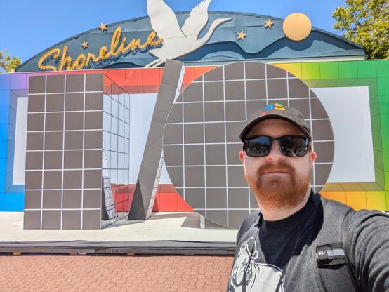 A selfie in front of the giant I/O sign, wearing sunglasses and looking cool in the bright sun.