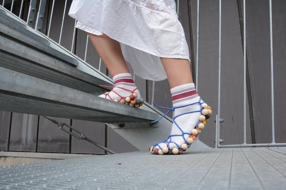 Pictures of feet wearing modular shoes