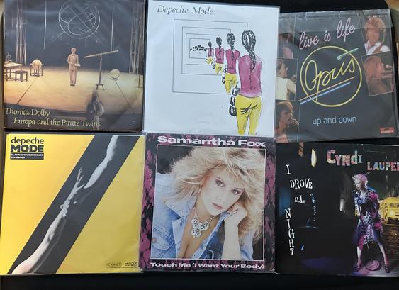 7-inch singles, from top left clockwise: Thomas Dolby/Europa and the Pirate twins, Drpeche Mode/Dreaming of me, Opus/Live is lofe, Cyndi Lauper/I drove all night, Samantha Fox/Touch me (I want your body), Depeche Mode/Blasphemous rumours