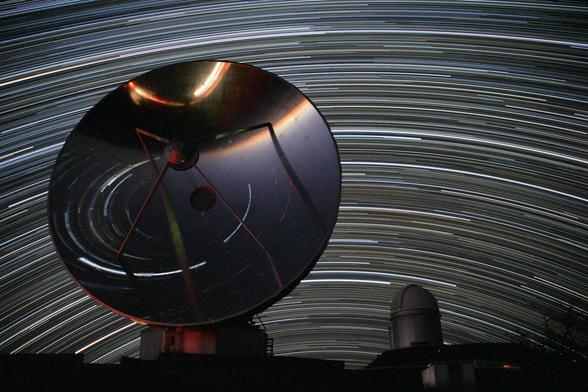 2012 February 2

La Silla Star Trails North and South
 * Image Credit & Copyright: Alexandre Santerne (Laboratoire d'Astrophysique de Marseille / Observatoire de Haute Provence)

Explanation: 
If the tripod is set up at ESO's La Silla Observatory, high in the Atacama desert of Chile, your star trails would look something like this. Spanning about 4 hours on the night of January 24, the image is actually a composite of 250 consecutive 1-minute exposures, looking toward the north. The North Celestial Pole, at the center of the star trail arcs, is just below the horizon in this southern hemisphere perspective. In the foreground, the polished 15-meter diameter dish antenna of the Swedish-ESO Submillimeter Telescope (now decommissioned) shows star trails toward the south by reflection. Sweeping around the South Celestial Pole, the distorted arcs of those stars appear underneath the southern horizon in the focusing dish's inverted view. Right of the dish is the dome of the observatory's 3.6 meter telescope, home to the planet hunting HARPS spectrograph. 

Authors & editors: Robert Nemiroff (MTU) & Jerry Bonnell (UMCP)
NASA Official: Phillip Newman Specific rights apply.
NASA Web Privacy Policy and Important Notices
A service of: ASD at NASA / GSFC
& Michigan Tech. U.