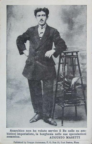 a dapper early 1900s italian anarchist, leaning on a table