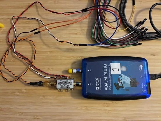 Desktop photo showing detector attached to TX-Out port of ADALM-Pluto SDR. Used SATSAGEN software to control the Pluto TX as a signal generator (setting frequency and RF Out level).