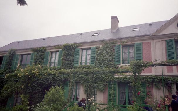 The facade of a house covered in vines