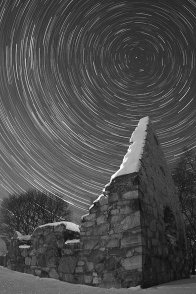 2010 December 24

Star Trails in the North
 * Image Credit & Copyright: P-M Hedén (Clear Skies, TWAN)

Explanation: 
Pointing skyward, the wall of this ruined Viking church still stands after a thousand winters, near the town of Vallentuna, Sweden. The time exposure records the scene on December 14th as stars leave graceful arcing trails during a long night, reflecting planet Earth's daily rotation on its axis. The Earth's axis points toward Polaris, the North Star, near the center of the concentric trails. Welcomed by skygazers on this winter's night, a bright meteor from the annual Geminid meteor shower also flashes through the frame. The meteor cuts across the star trails just above the lower church wall. Contributing to the beautiful composition, meteor streak and church apex both gesture toward the North Celestial Pole. 

Authors & editors: Robert Nemiroff (MTU) & Jerry Bonnell (UMCP)
NASA Official: Phillip Newman Specific rights apply.
NASA Web Privacy Policy and Important Notices
A service of: ASD at NASA / GSFC
& Michigan Tech. U.