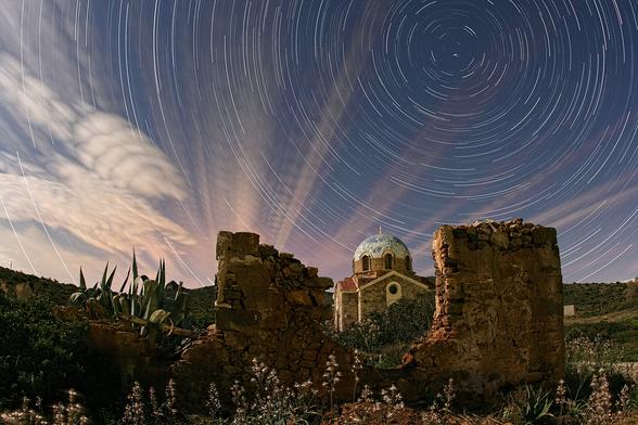 2010 March 15

Illuminated Cloud Trails Above Greece
 * Credit & Copyright: Chris Kotsiopoulos

Explanation: 
It may appear to be day, but it's night. Those wondrous orange streaks may appear to be rays from the setting Sun, but they're actually thin clouds illuminated by the Moon as they quickly streaked toward the distant horizon. The thick clouds on the far left may appear to have many layers, but actually they are just a few simple clouds captured on numerous separate exposures. What is surely true, though, is that the above time lapse image sequence was taken over two hours, about two weeks ago, in Sounio, Greece. Also, those really are star trails swirling around the north star Polaris on the upper right of the image. But what about the building in the foreground? It may appear to be a famous ancient structure, but it's actually a small deserted church built only last century. 

Authors & editors: Robert Nemiroff (MTU) & Jerry Bonnell (UMCP)
NASA Official: Phillip Newman Specific rights apply.
NASA Web Privacy Policy and Important Notices
A service of: ASD at NASA / GSFC
& Michigan Tech. U.