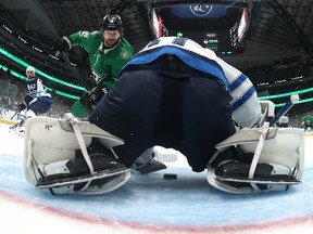 Sam Steel #18 of the Dallas Stars takes a shot on Connor Hellebuyck #37 of the Winnipeg Jets during the first period in Game Six of the Second Round of the 2025 Stanley Cup Playoffs at American Airlines Center on May 17, 2025 in Dallas, Texas.