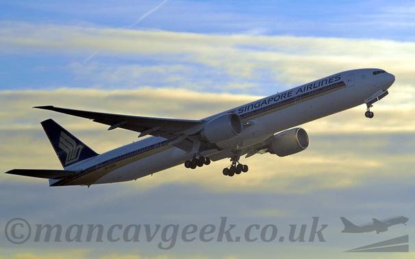 Side view of a white, twin engined jet airliner flying from right to left at a low altitude, just after taking off.
There is a purple, orange, and gold stripe running along the body, and purple "Singapore Airlines" titles on the upper forward fuselage.
The tail is purple, with a golden stylised flying bird,
Pale blue sky with streaks of white cloud fills the background.