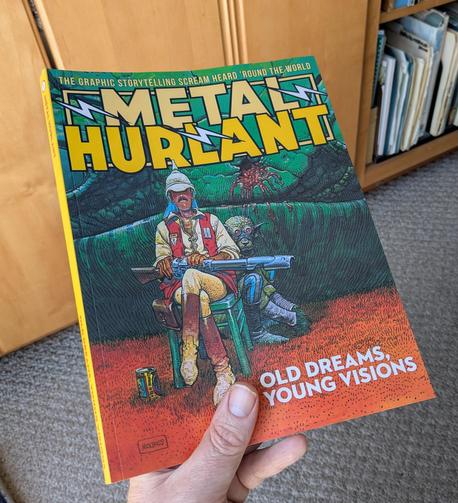 A quarterly collected METAL HURLANT as a 200+ page collection of classic and new comic work for adult audiences. The cover image is Mobius' Major Grubert from 'The Airtight Garage' with his lean build, pith helmet and iconic mustache. He sits in from of jungle foliage.